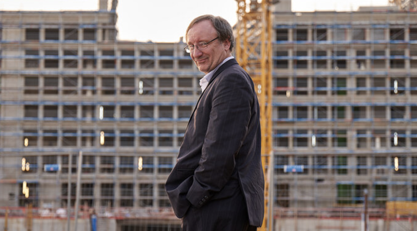 the main actor in front of a big construction