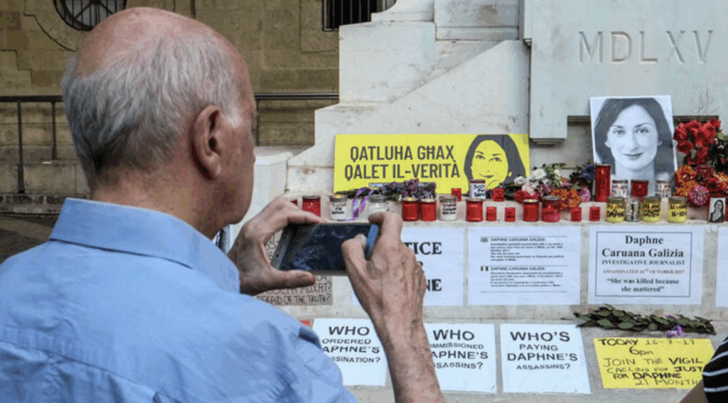 a man is taking photos from a memorial of galizia