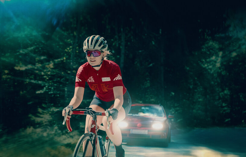 Nathalie on her bike on the escape of a car